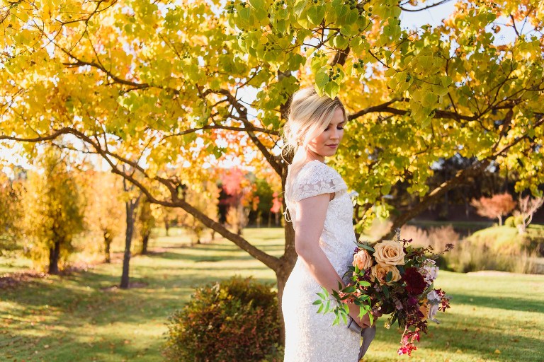 Core cider bridal boquet wedding dress porttrait by Melissa's Photography